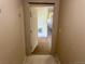 Hallway leads to another room with off-white walls, and a door leading outside at 5726 N Genoa Way # 301, Aurora, CO 80019