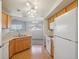 A fully equipped kitchen with wood cabinets and adjacent dining room offering ample natural light at 5726 N Genoa Way # 301, Aurora, CO 80019