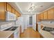 Bright kitchen showcasing wood cabinets, a white refrigerator and an electric range at 5726 N Genoa Way # 301, Aurora, CO 80019