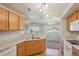 Bright kitchen with wood cabinets and pass-through window to adjacent room at 5726 N Genoa Way # 301, Aurora, CO 80019