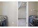 Laundry room featuring modern appliances and open doorway, offering functionality and style at 5726 N Genoa Way # 301, Aurora, CO 80019