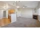 Open-concept living room blending seamlessly with the kitchen, featuring a cozy fireplace at 5726 N Genoa Way # 301, Aurora, CO 80019