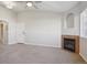 Comfortable living room with a fireplace, neutral carpet, and access to other areas at 5726 N Genoa Way # 301, Aurora, CO 80019