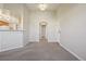 A spacious living room featuring carpet and access to the kitchen at 5726 N Genoa Way # 301, Aurora, CO 80019
