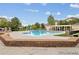 Community swimming pool surrounded by a brick retaining wall and nearby cabana at 5726 N Genoa Way # 301, Aurora, CO 80019