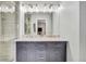 Double sink bathroom with a large mirror and vanity lighting at 6414 Stuart St, Arvada, CO 80003