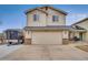 Charming two-story home with a spacious two-car garage and a long driveway for extra parking at 6414 Stuart St, Arvada, CO 80003