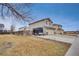 Two-story home featuring a long driveway, large front yard, and an attached garage, perfect for storage and parking at 6414 Stuart St, Arvada, CO 80003