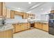 Well-lit kitchen with wood cabinets, stainless steel appliances, and a functional layout for easy meal preparation at 6414 Stuart St, Arvada, CO 80003