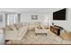 Bright living room featuring a large sectional sofa, decorative rug, and entertainment center at 6414 Stuart St, Arvada, CO 80003