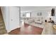 Spacious living room features hardwood floors, sectional sofa, and view of the stairs offering an inviting atmosphere at 6414 Stuart St, Arvada, CO 80003