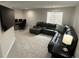 Cozy living room area features plush gray carpet, a large sectional couch, and a workspace with monitors at 6414 Stuart St, Arvada, CO 80003