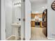 Compact powder room with pedestal sink, view to the kitchen at 6414 Stuart St, Arvada, CO 80003