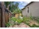 Cozy backyard with lush landscaping, a small patio and wooden privacy fence at 109 W Simpson St, Lafayette, CO 80026