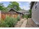 Backyard with garage and pebble ground cover plus a stone paver walkway at 109 W Simpson St, Lafayette, CO 80026