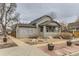 Exterior view of home highlighting the covered porch, updated landscaping, and neutral color palette at 109 W Simpson St, Lafayette, CO 80026