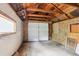 Spacious garage interior featuring a wooden ceiling, side storage and double doors at 109 W Simpson St, Lafayette, CO 80026