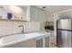 A well-lit kitchen with modern stainless steel refrigerator and tiled backsplash at 109 W Simpson St, Lafayette, CO 80026