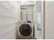 Convenient laundry area with a Samsung washer and overhead shelving at 109 W Simpson St, Lafayette, CO 80026