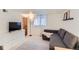 Comfortable living room featuring a gray sofa, entertainment center, and patterned rug at 109 W Simpson St, Lafayette, CO 80026