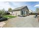 Rear view of the house with a gravel yard, a small lawn and a small deck at 9768 Otis Dr, Broomfield, CO 80021