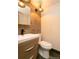 Cozy bathroom featuring modern sink with wood-look vanity and dark accents at 9768 Otis Dr, Broomfield, CO 80021