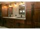 Stylish bathroom featuring double vanity with undermount sink and wood cabinets at 9768 Otis Dr, Broomfield, CO 80021
