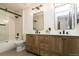 Stylish bathroom showcasing a double vanity, modern mirrors, and a sleek walk-in shower at 9768 Otis Dr, Broomfield, CO 80021