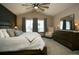 Inviting bedroom with vaulted ceiling, ceiling fan, dresser, and large windows with natural light at 9768 Otis Dr, Broomfield, CO 80021