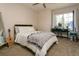 Bright bedroom with a large window, simple desk and comfortable decor and natural lighting at 9768 Otis Dr, Broomfield, CO 80021