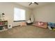 Cozy bedroom with comfortable seating, soft lighting and a large window providing plenty of daylight at 9768 Otis Dr, Broomfield, CO 80021