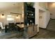 Contemporary dining area featuring hardwood floors, modern light fixtures, and custom coffee bar and wine storage area at 9768 Otis Dr, Broomfield, CO 80021