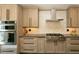 Contemporary kitchen showcasing stainless steel appliances, and sleek gray cabinetry at 9768 Otis Dr, Broomfield, CO 80021