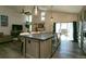 Open-concept kitchen island and living space featuring stainless steel appliances and a large sliding door at 9768 Otis Dr, Broomfield, CO 80021
