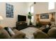Bright living room with two sofas, high ceilings, and large windows at 9768 Otis Dr, Broomfield, CO 80021
