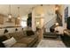 Open-concept living room featuring a sofa, custom lighting, and hardwood floors at 9768 Otis Dr, Broomfield, CO 80021