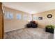 Spacious bedroom featuring neutral carpet, natural light and black leather chair at 7661 Chickaree Ct, Littleton, CO 80125