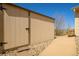 The property features an exterior shed with a sturdy door and concrete pathway surrounded by decorative stones at 7661 Chickaree Ct, Littleton, CO 80125