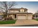 Inviting two-story home featuring a covered porch and a spacious three-car garage at 7661 Chickaree Ct, Littleton, CO 80125