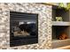 Close up of fireplace with stone detail and surrounding decorative shelves at 7661 Chickaree Ct, Littleton, CO 80125