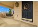 Welcoming front porch featuring a swing and a beautifully decorated front door at 7661 Chickaree Ct, Littleton, CO 80125