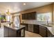 Kitchen featuring granite countertops, an island, gray cabinets, and stainless steel appliances at 7661 Chickaree Ct, Littleton, CO 80125
