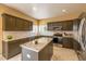 Modern kitchen featuring granite countertops, stainless steel appliances, and a center island at 7661 Chickaree Ct, Littleton, CO 80125