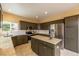 Modern kitchen with an island, granite countertops, stainless steel appliances, and custom cabinets at 7661 Chickaree Ct, Littleton, CO 80125