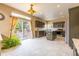 Bright kitchen boasts stainless appliances, gray cabinets, granite counters, and a sliding door to the deck at 7661 Chickaree Ct, Littleton, CO 80125