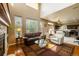 Bright living room with hardwood floors, fireplace, and lots of natural light at 7661 Chickaree Ct, Littleton, CO 80125