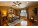 Vaulted ceiling bedroom with natural light, a four-poster bed, and hardwood floors at 7661 Chickaree Ct, Littleton, CO 80125