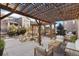Charming backyard patio with a pergola, fire pit, string lights, and comfortable seating areas at 15980 Pikes Peak Dr, Broomfield, CO 80023