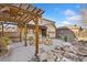 Backyard patio featuring a pergola, fire pit, and comfortable seating, perfect for outdoor living at 15980 Pikes Peak Dr, Broomfield, CO 80023