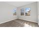 Inviting bedroom with plush carpeting, neutral walls, and large windows, offering ample natural light and street views at 15980 Pikes Peak Dr, Broomfield, CO 80023